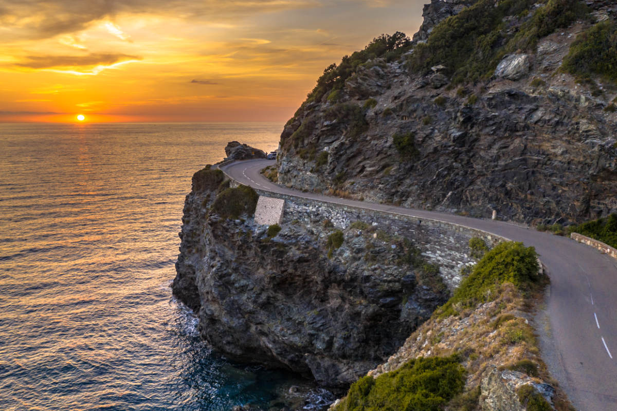 A winding road in Cap Corse at sunset in Corsica.