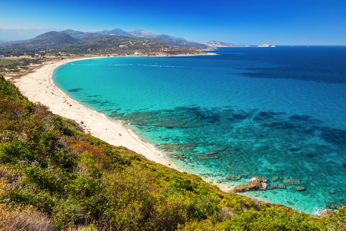 White sand and turquoise sea at Lozari Beach in Corsica.